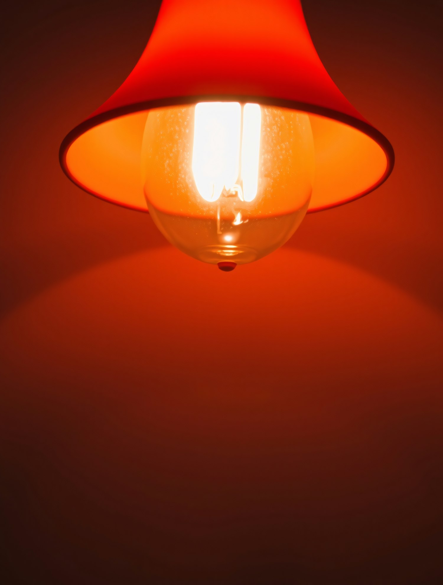 Close-up of Light Bulb in Red Lampshade