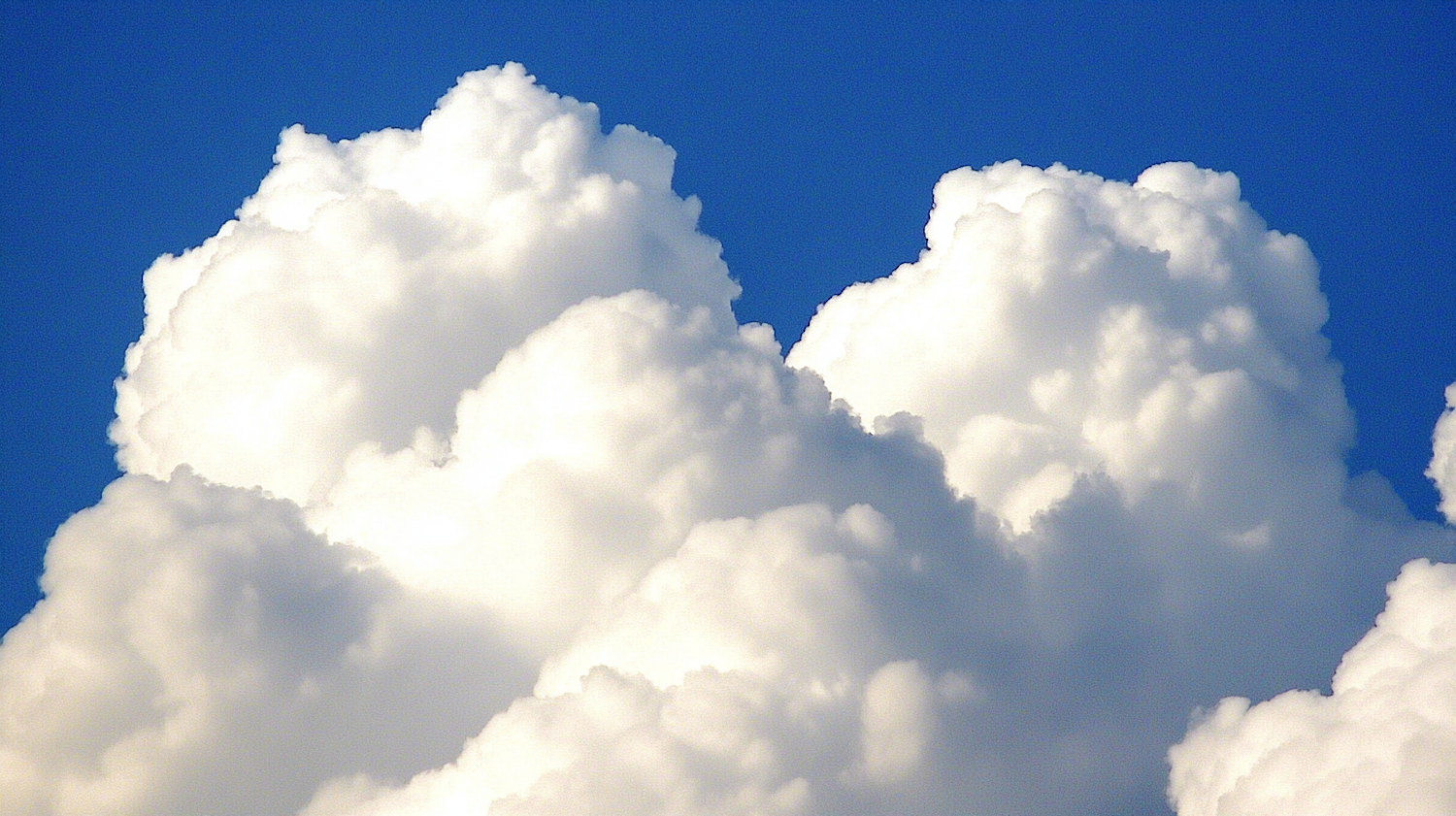 Cumulus Clouds Against Blue Sky