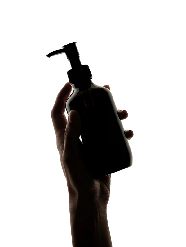 Hand Holding Pump Bottle