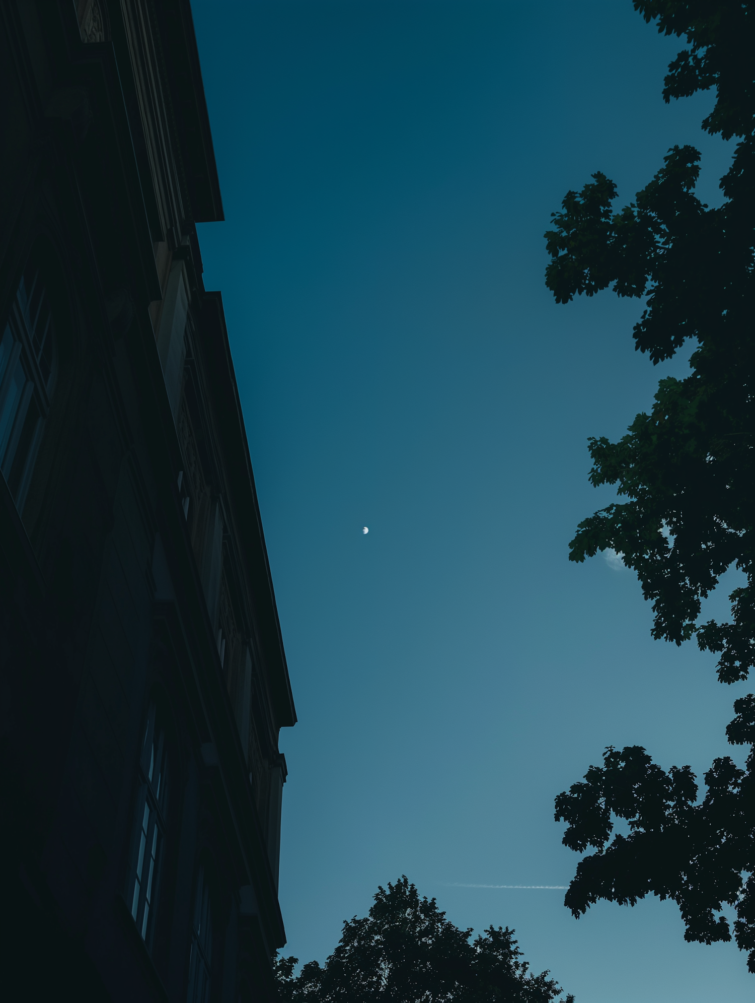 Tranquil Sky with Crescent Moon and European Architecture