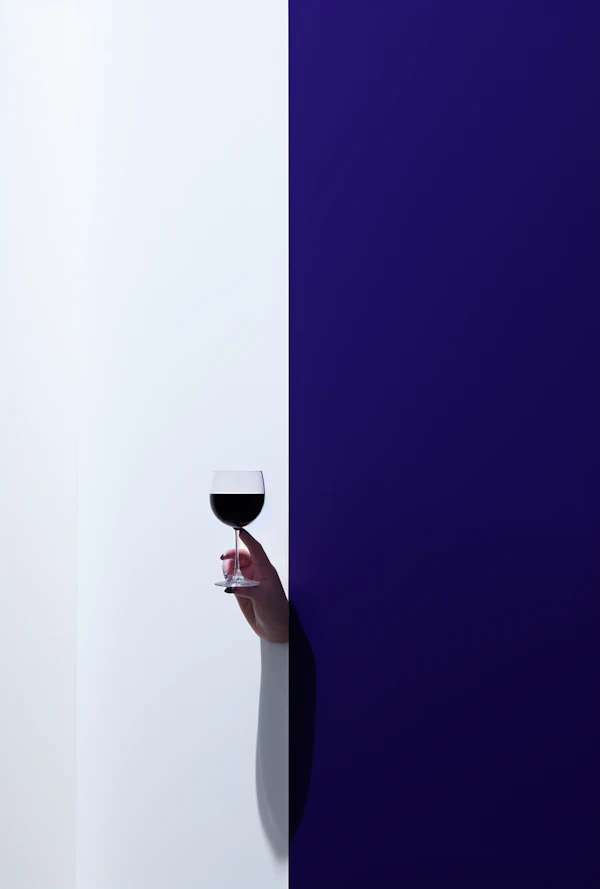 Elegance in Contrast: Hand with Wine Glass