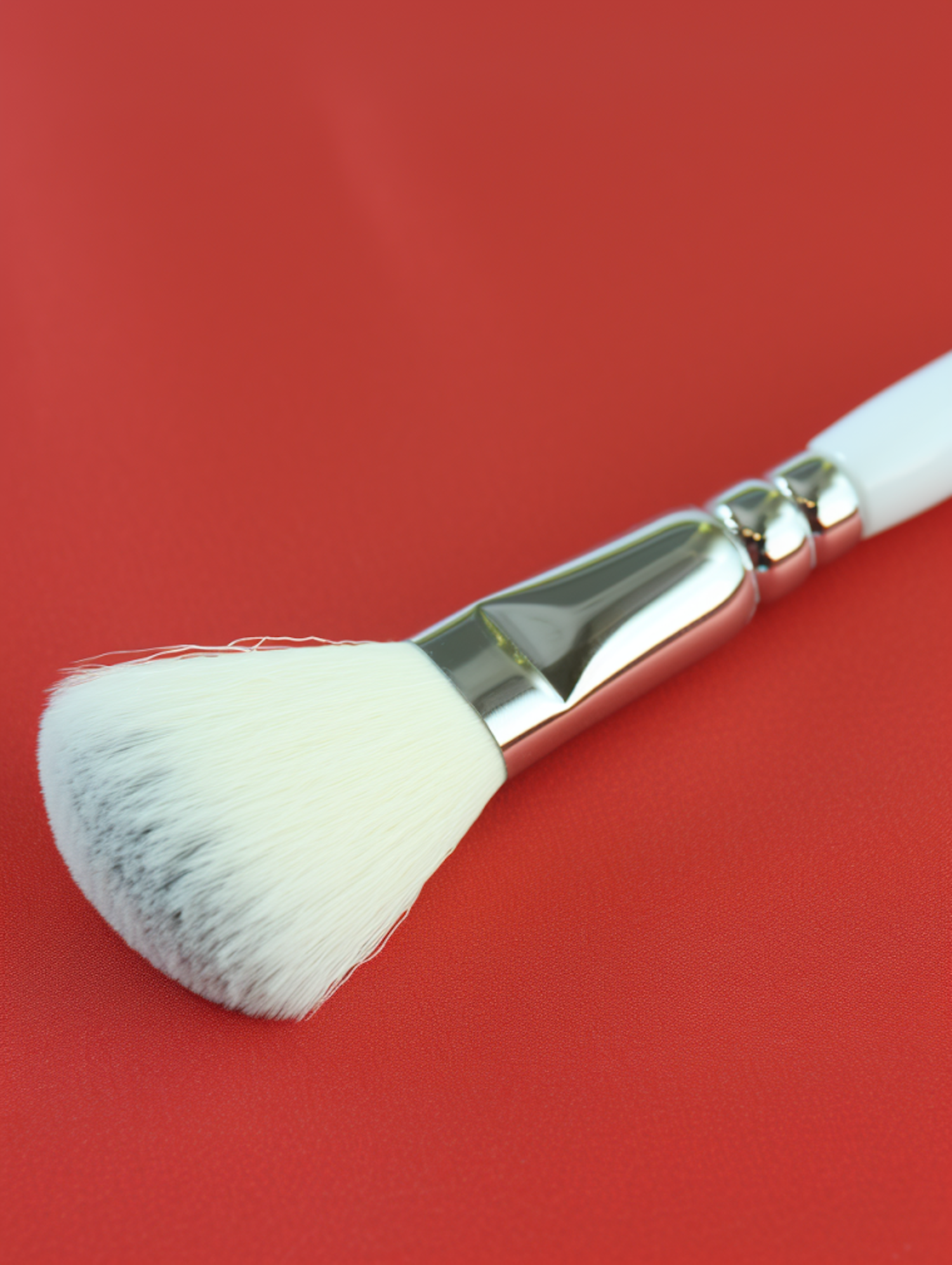 Elegant White Powder Makeup Brush on Red