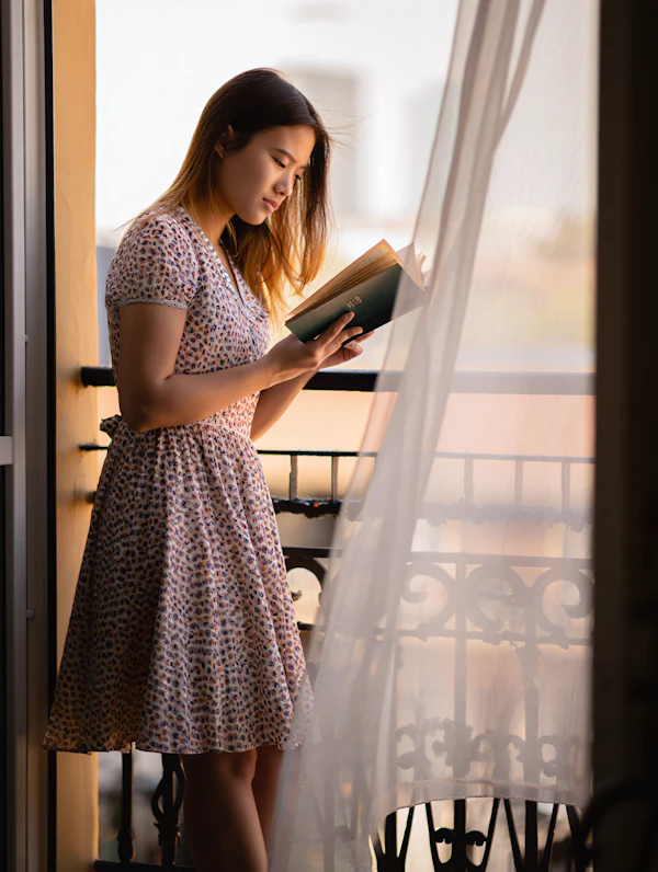 Woman Reading on Balcony