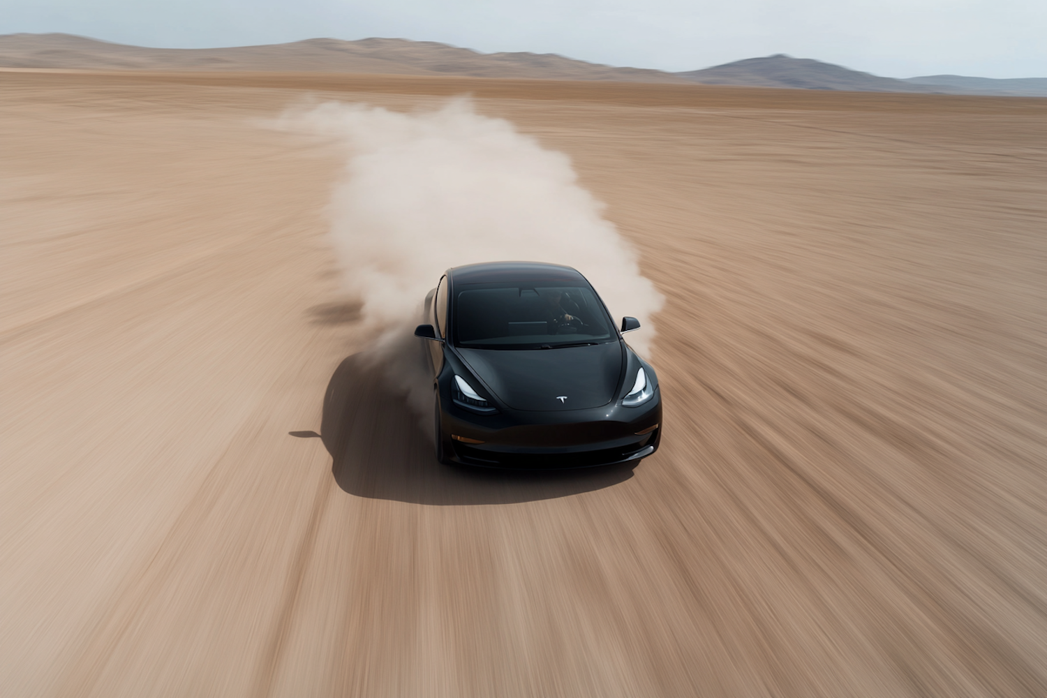 Sleek Black Car in Desert