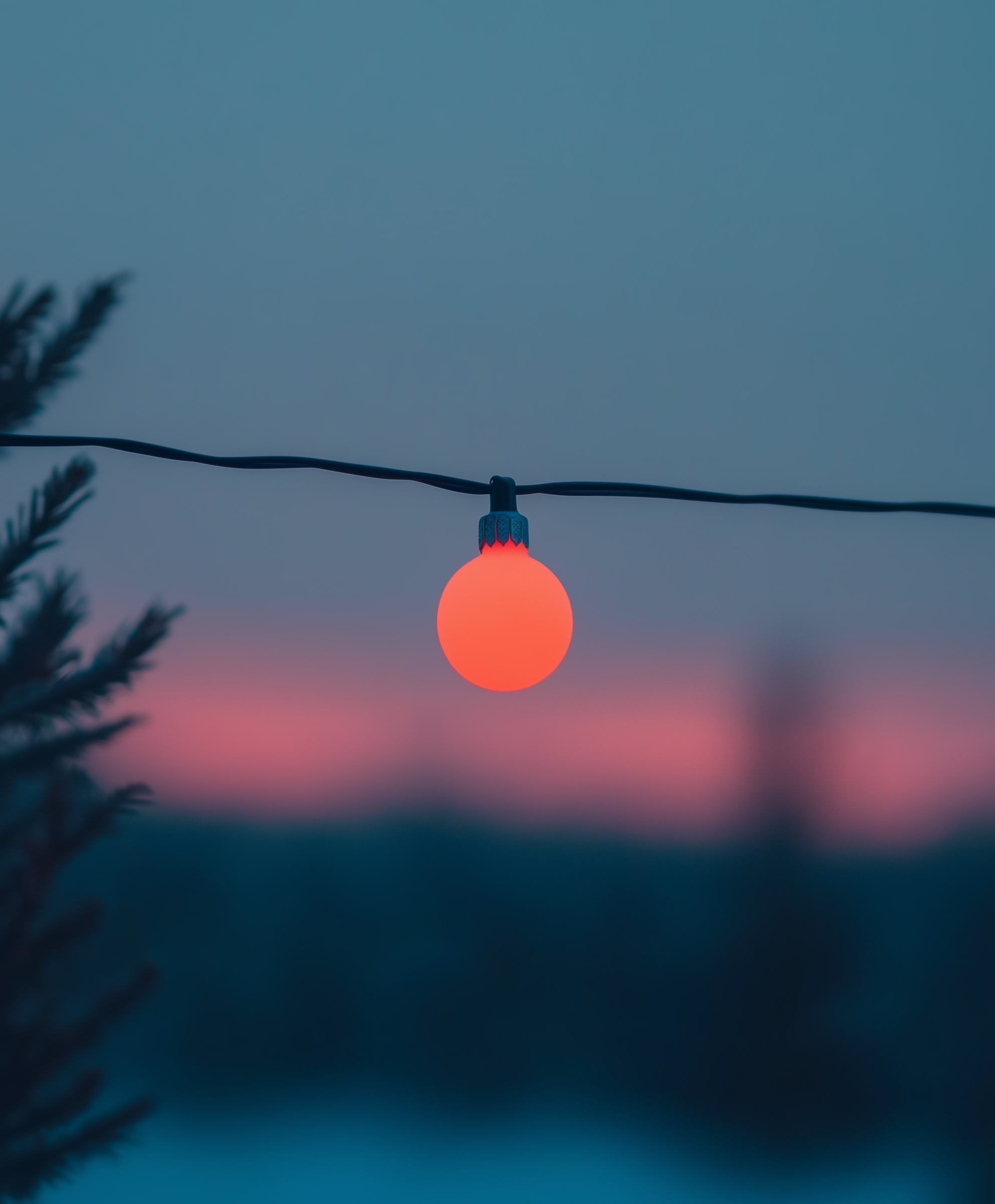 Glowing Red Bulb at Dusk