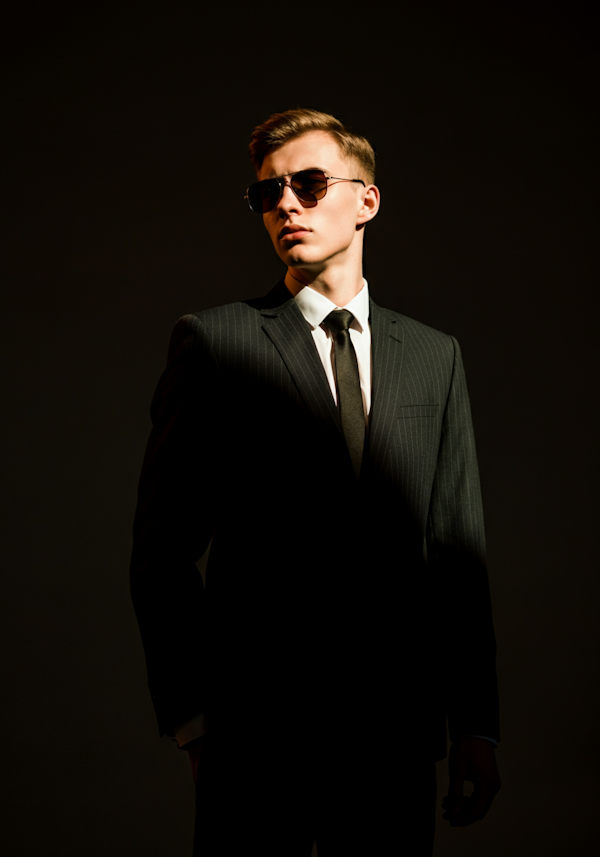 Man in Dark Pinstripe Suit with Dramatic Lighting