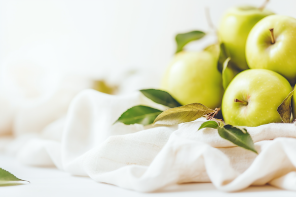 Pristine Granny Smith Apples on White Linen