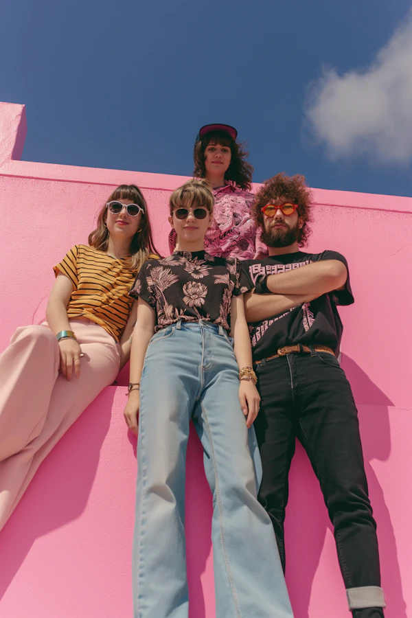 Urban Cool Fashion Quartet Against Pink Wall