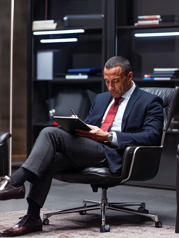 Man Working on Tablet in Modern Office