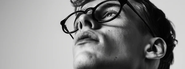 Contemplative Young Man in Glasses