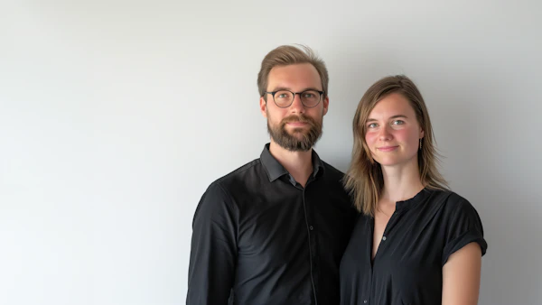Casual Professional Pair Against Off-White Backdrop