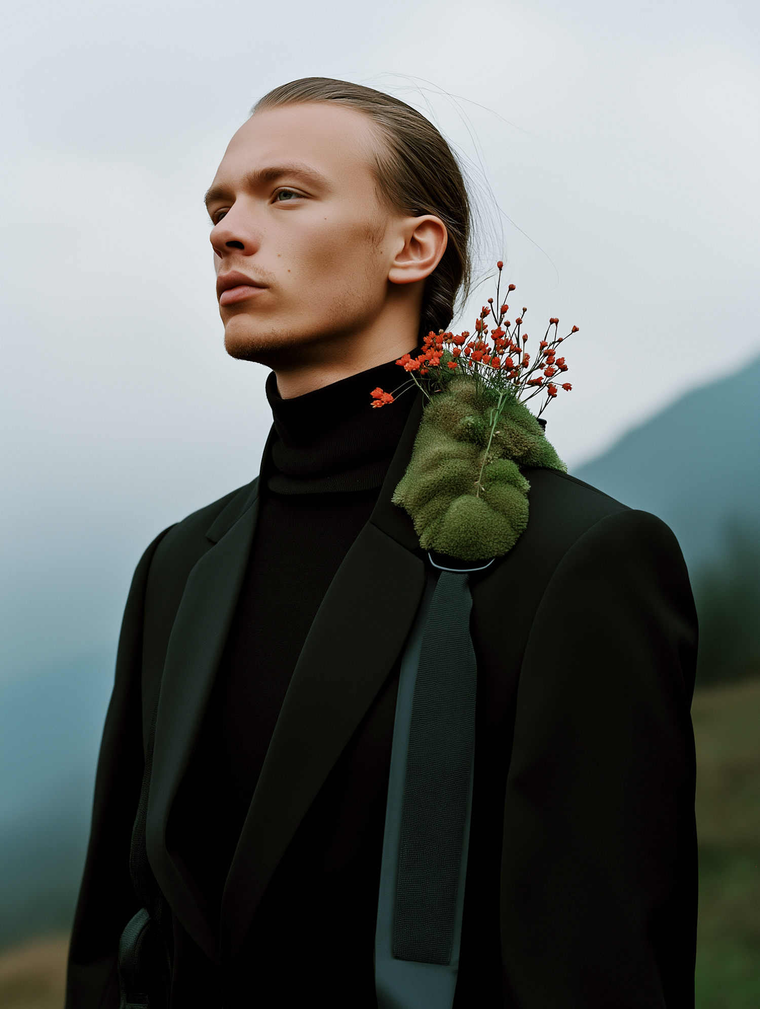 Contemplative Young Man with Floral Accent