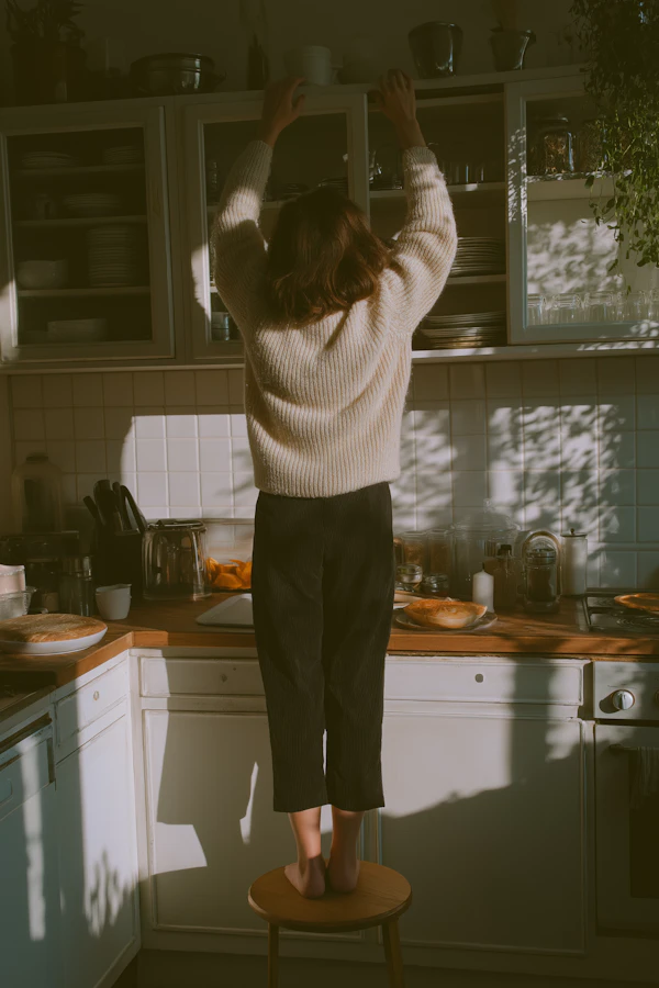 Woman Reaching in Kitchen