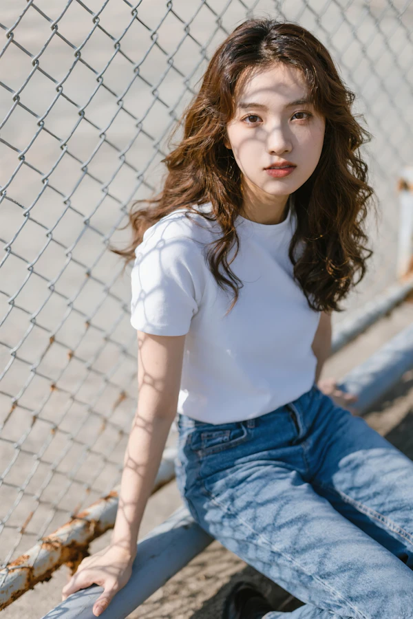 Woman in Sunlit Fence
