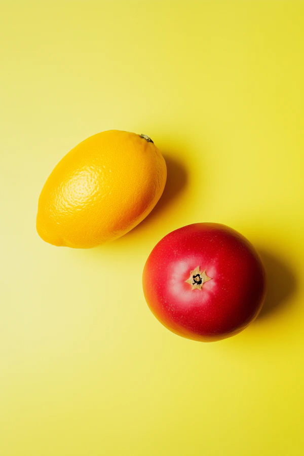 Lemon and Tomato on Yellow Background