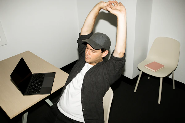 Man Stretching in Office
