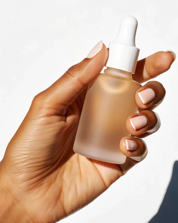 Hand with Dropper Bottle