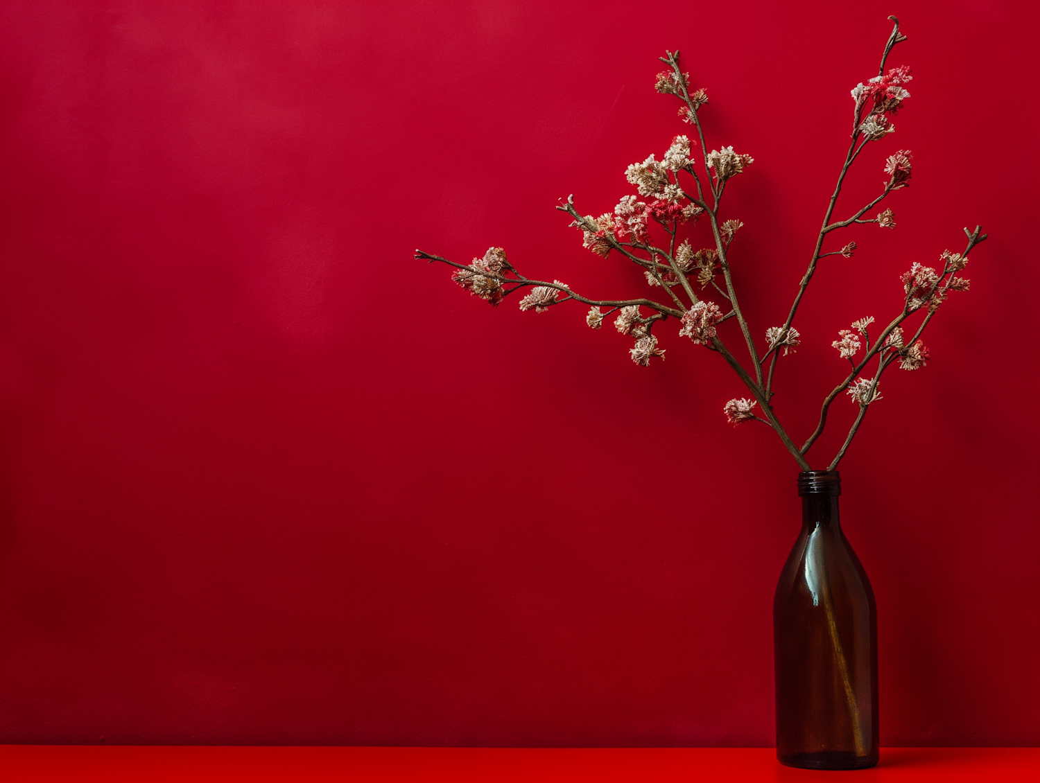 Minimalist Composition with Amber Glass Bottle and Dried Flowers