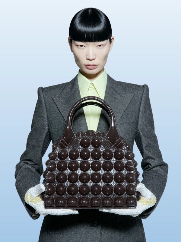 Elegant Portrait of Model Holding Brown Handbag