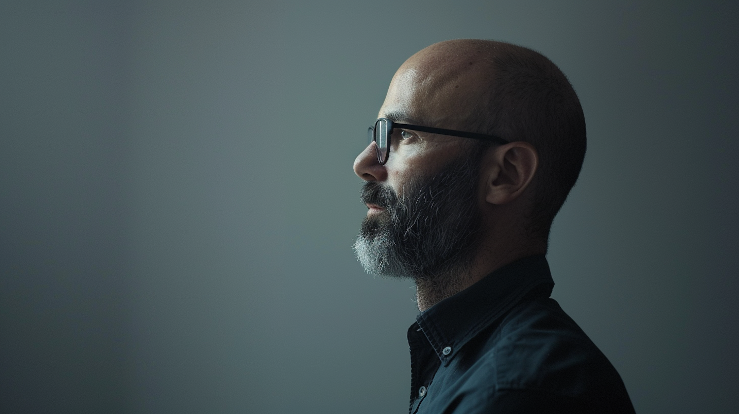 Contemplative Man with Beard and Glasses