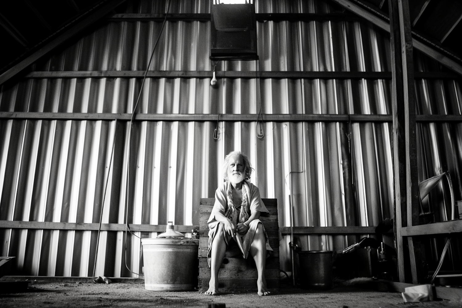 Contemplative Figure in Rustic Industrial Scene