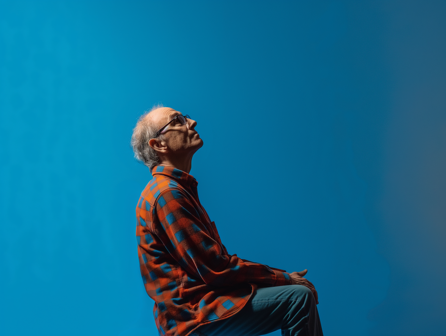 Contemplative Older Man with Blue Background