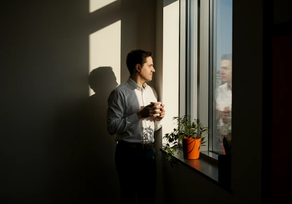 Contemplative Man by Window