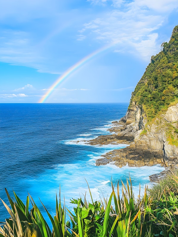 Serene Coastal Landscape with Rainbow