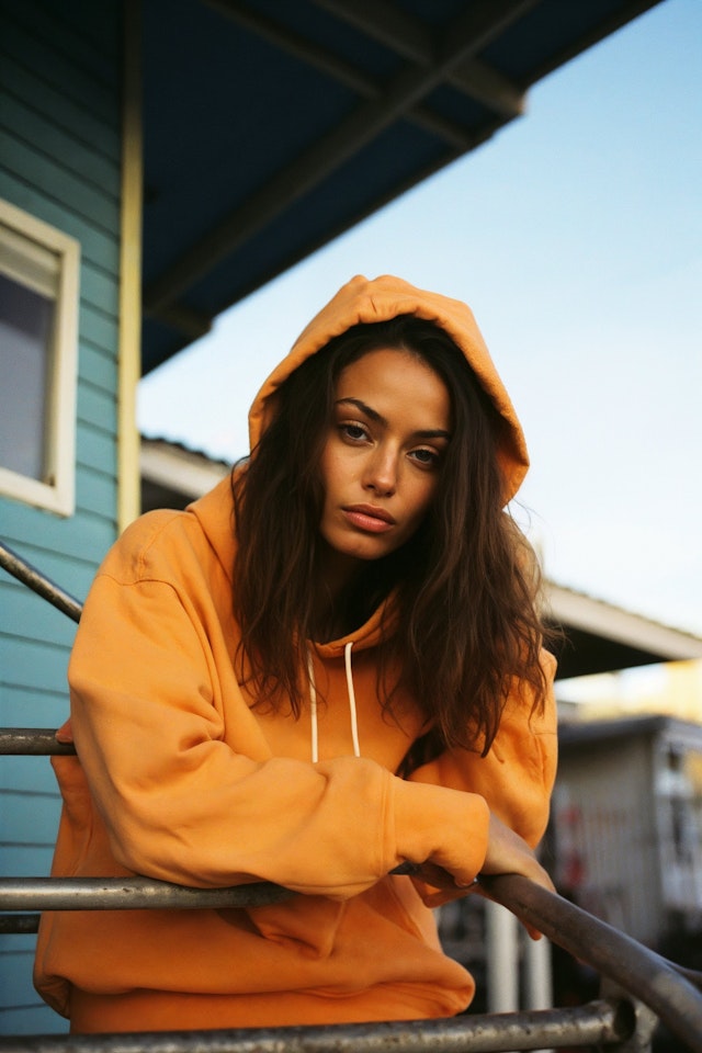 Contemplative Woman in Orange Hoodie