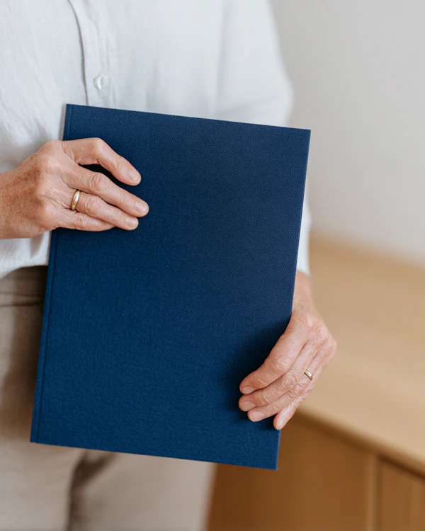 Hands Holding Blue Folder