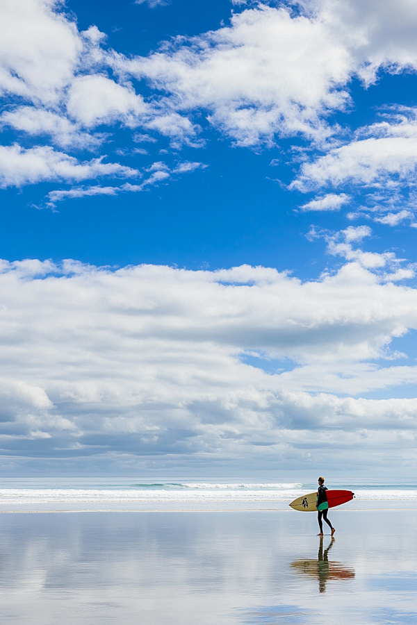 Lone Surfer on Serene Beach