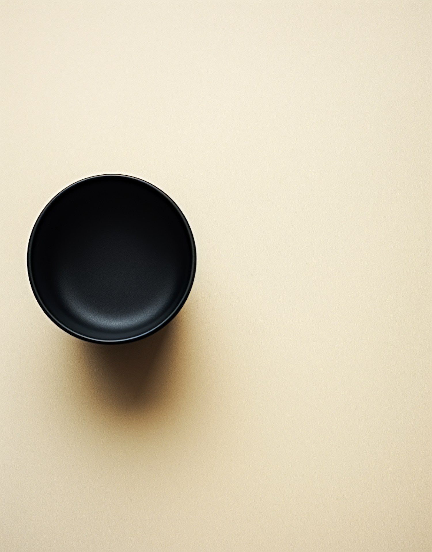 Minimalist Black Cup on Beige Background