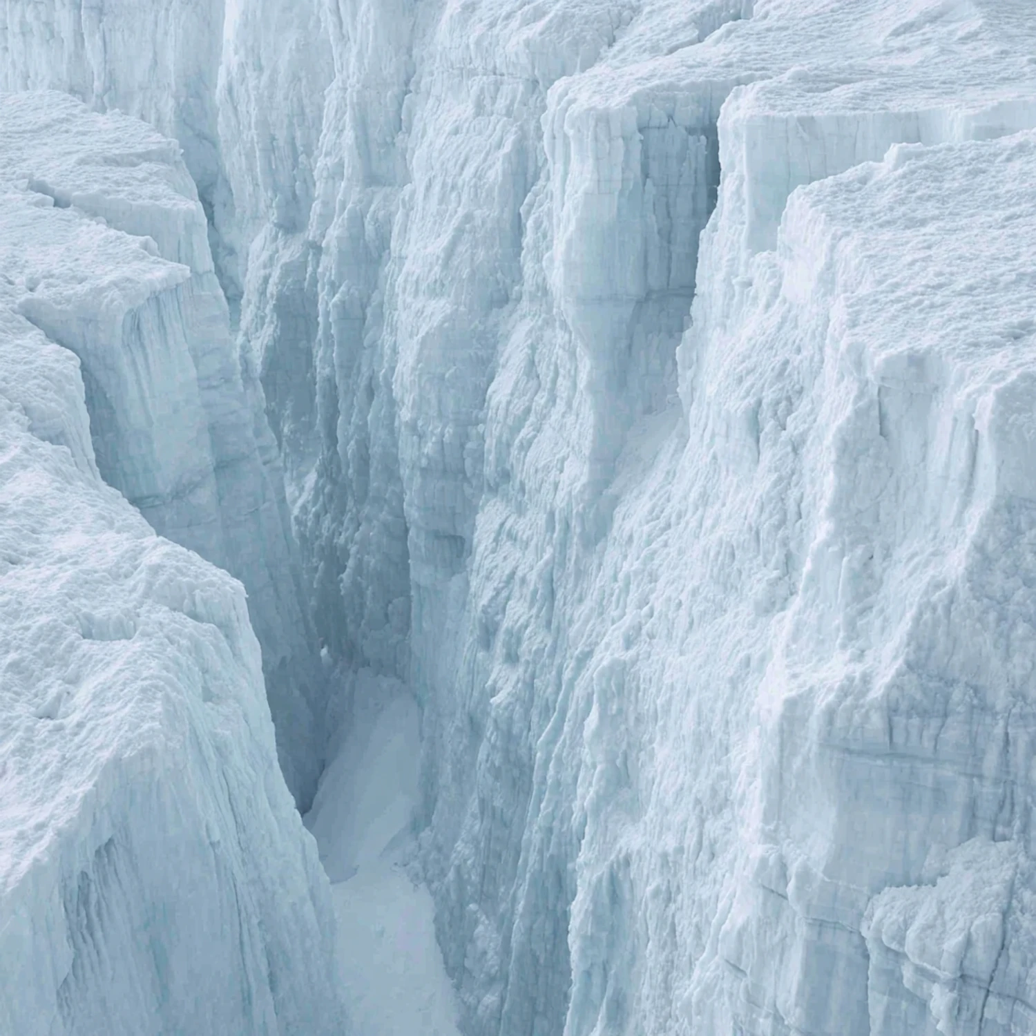 A towering ice canyon with walls of glacial blue and white