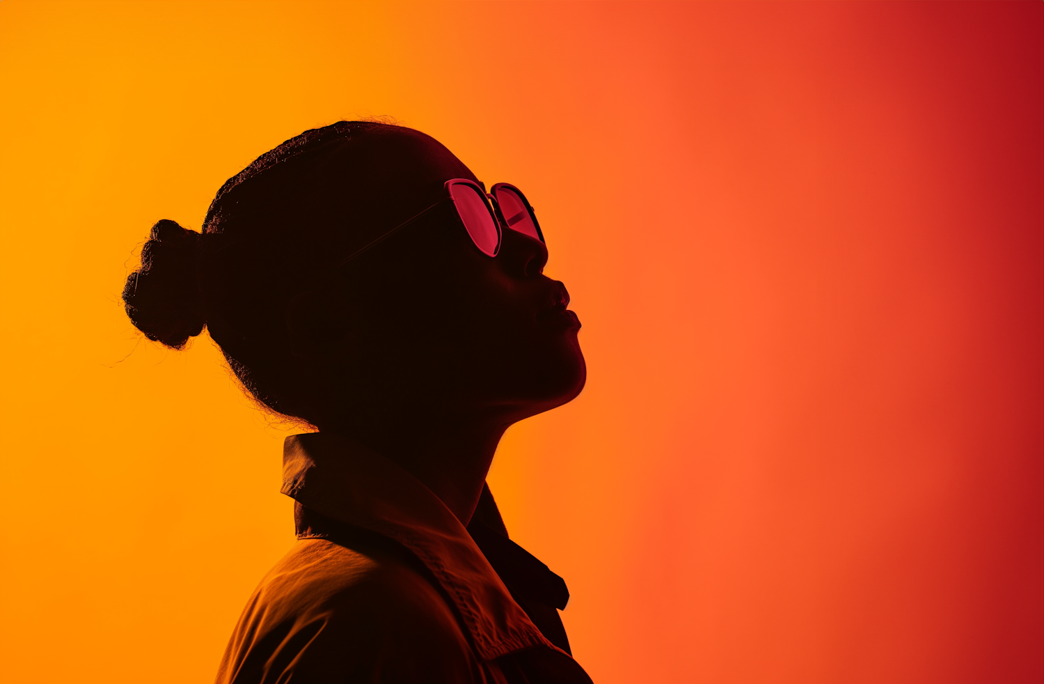 Contemplative Silhouette with Pink Sunglasses on Warm Gradient