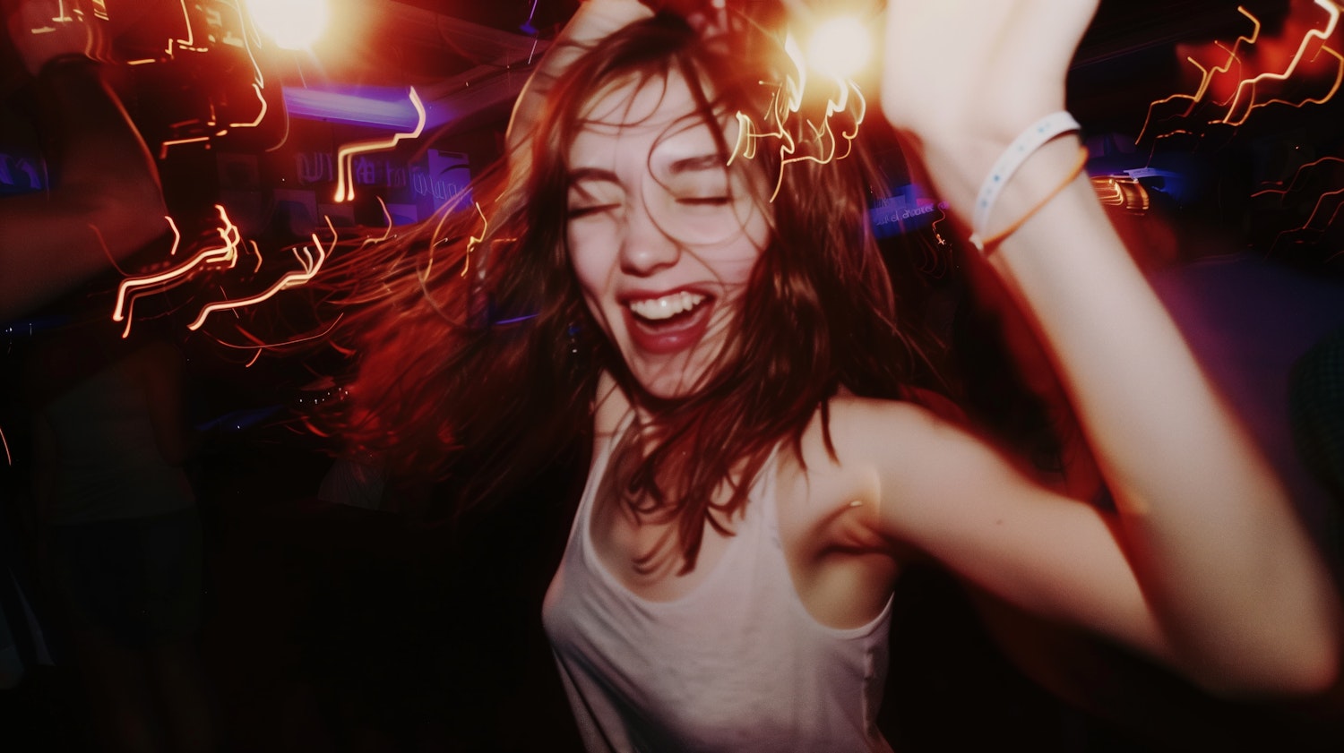 Exuberant Dancing Woman in Nightclub