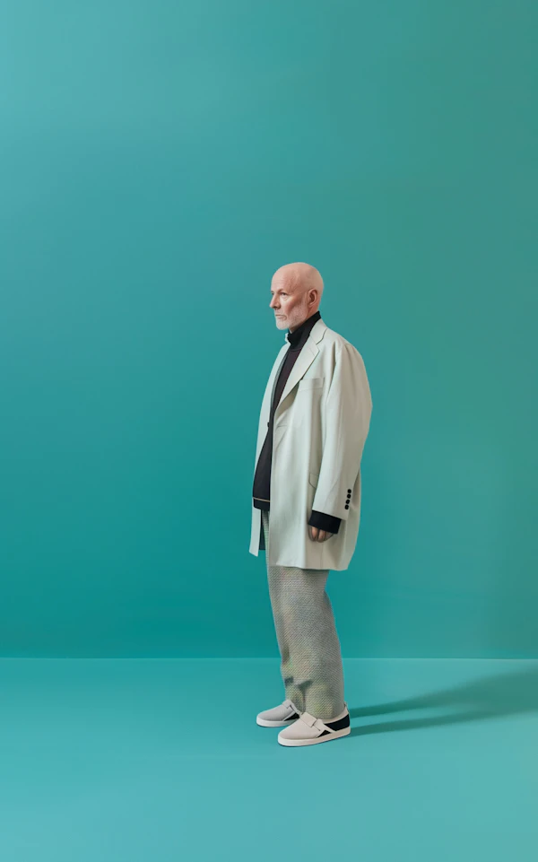 Fashionable Senior Man Against Turquoise Background