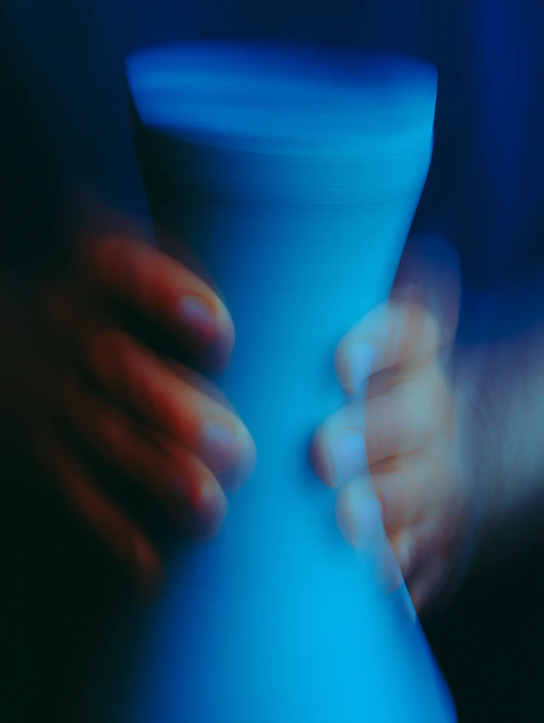 Hands Holding Blue Vase