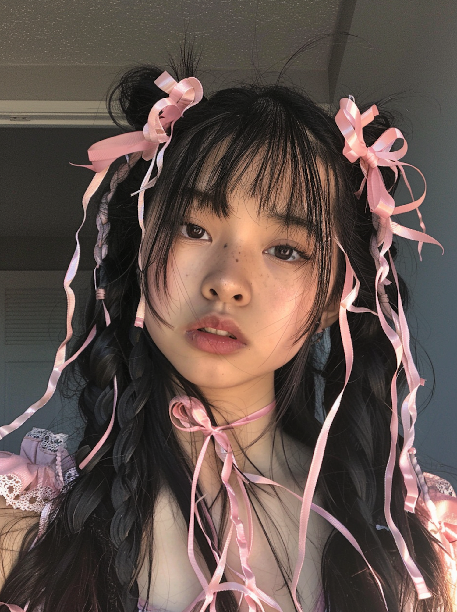 Young Woman with Braids and Pink Ribbons