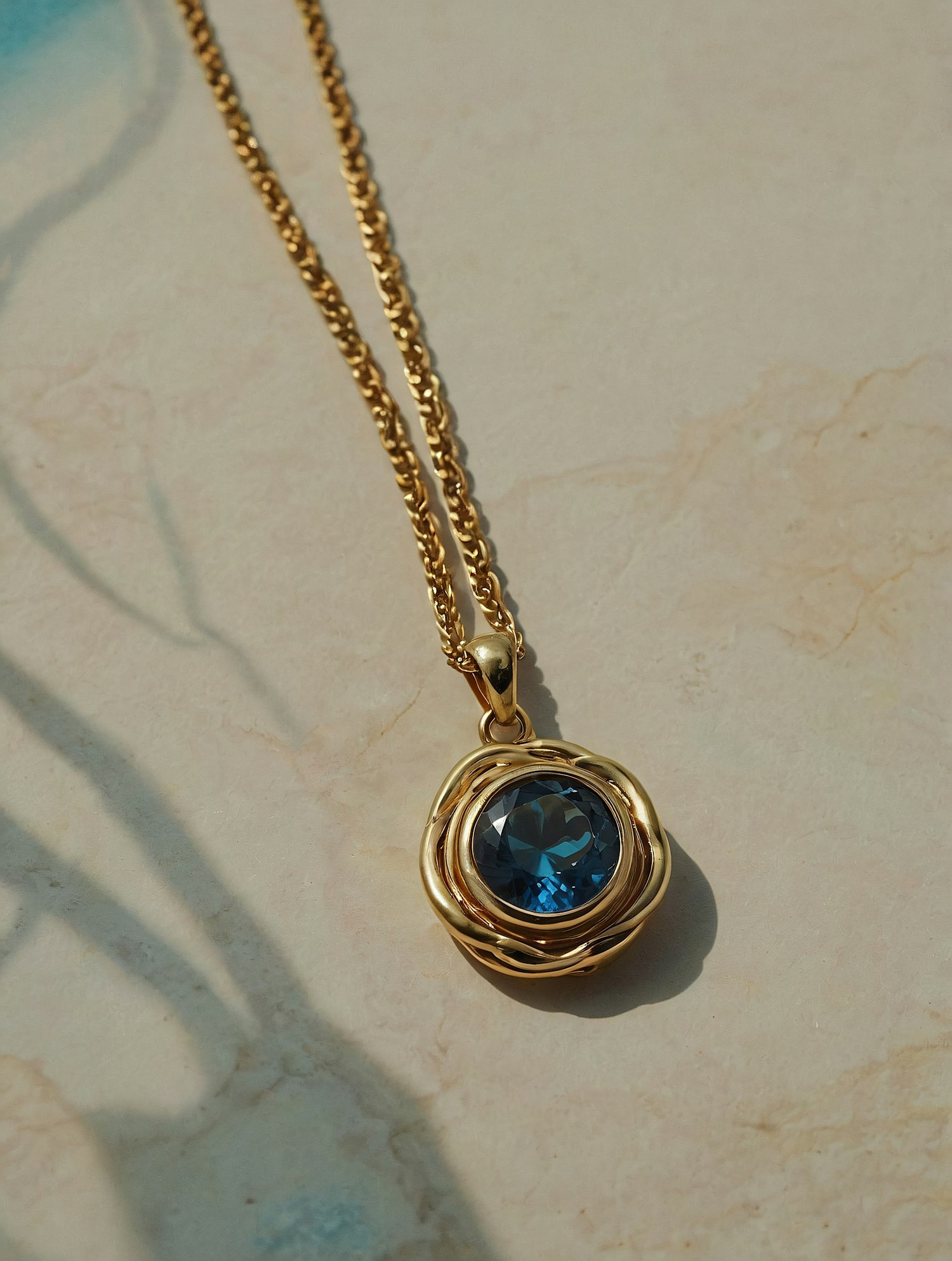 Gold Necklace with Blue Gemstone Pendant