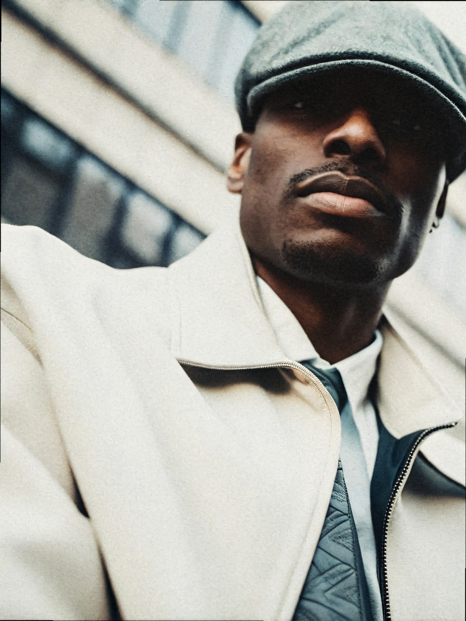 Man in Light-colored Coat and Flat Cap