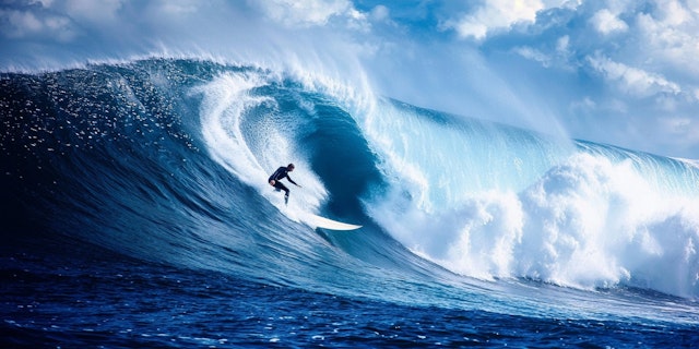 Surfer Riding a Massive Wave