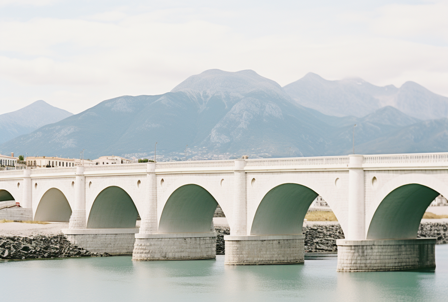 Tranquil Arched Bridge Amidst Misty Mountains