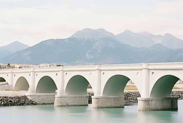 Tranquil Arched Bridge Amidst Misty Mountains