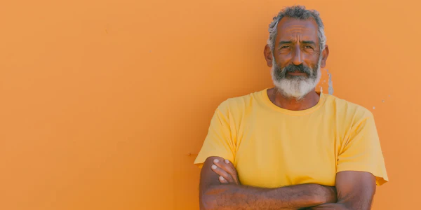 Contemplative Senior Man with Orange Background