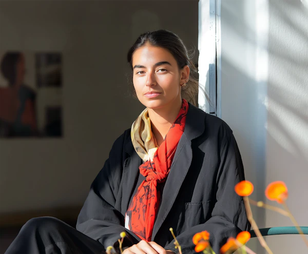 Contemplative Young Woman with Red Scarf
