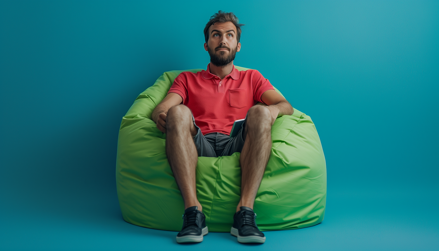 Casual Young Man Sitting in Bean Bag Chair