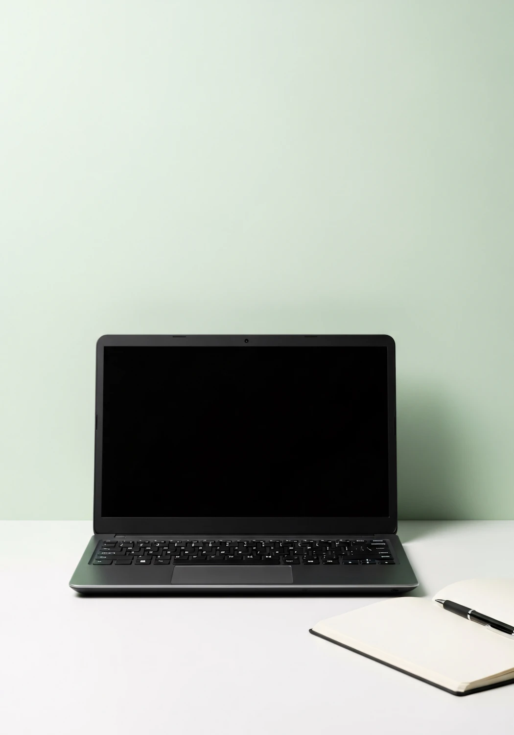 Minimalist workspace with a laptop and open notebook