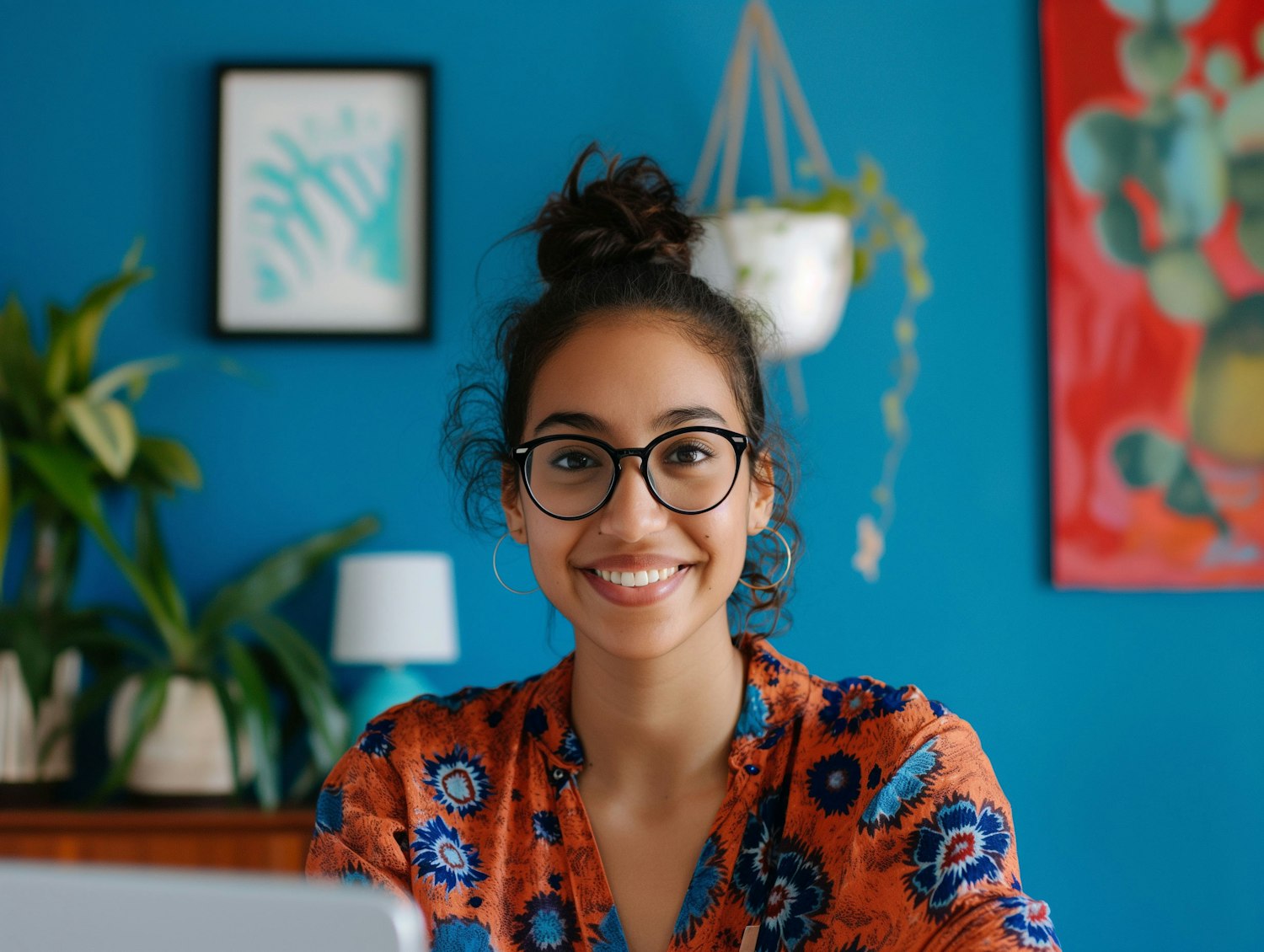 Smiling Woman with Glasses and Patterned Blouse