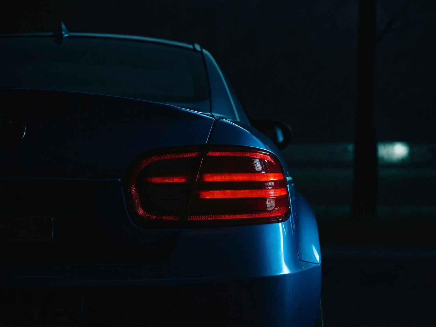 Blue Car with Illuminated Taillights