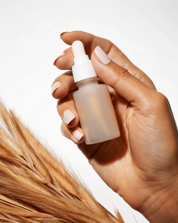 Hand with Dropper Bottle